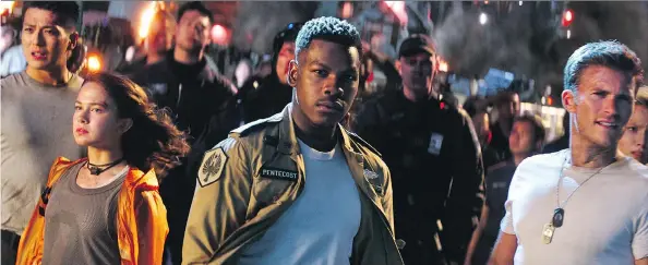  ?? PHOTOS: UNIVERSAL PICTURES ?? Cailee Spaeny, left, John Boyega and Scott Eastwood star in Pacific Rim Uprising, in which the real enemy is not Kaiju, but boredom.