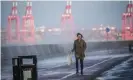  ?? Photograph: Christophe­r Furlong/Getty Images ?? A woman tries to avoid sea spray whipped up by wind and waves in New Brighton, Merseyside, as the UK readies for the arrival of Storm Barra.