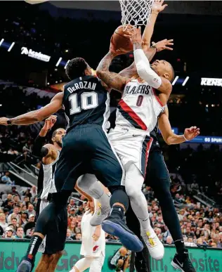  ??  ?? Portland’s Damian Lillard, center, has one of the most viewer-friendly styles of play, and he has leverage to ensure his team is in the best possible position when the season resumes.