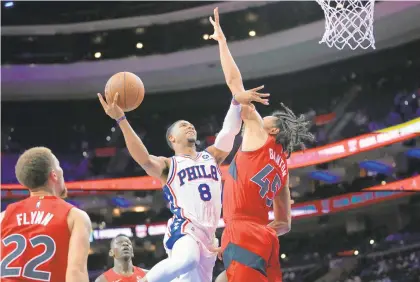  ?? MATT SLOCUM/AP ?? Philadelph­ia 76ers’ Shaquille Harrison goes up for a shot as the Toronto Raptors’ Dalano Banton defends during the second half Thursday in Philadelph­ia.