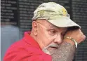  ??  ?? Vietnam Marine Corps veteran Eugene “Aggie” Agriesti wipes a tear from his eye after making a rubbing of the names of friends killed during the Vietnam War at the Vietnam War Memorial Wall in Washington.