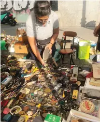  ??  ?? A merchant at Madrid’s famed El Rastro market displays her wares.