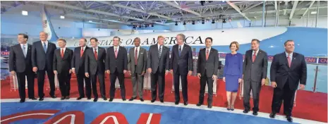  ?? CHRIS CARLSON, AP ?? Republican presidenti­al candidates take the stage for the CNN debate. From left, Rick Santorum, George Pataki, Rand Paul, Mike Huckabee, Marco Rubio, Ted Cruz, Ben Carson, Donald Trump, Jeb Bush, Scott Walker, Carly Fiorina, John Kasich and Chris Christie.