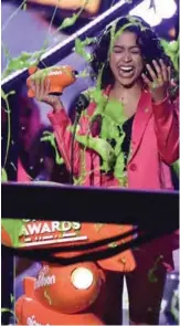  ??  ?? Liza Koshy gets slimed as she accepts the award for favorite funny YouTube creator.