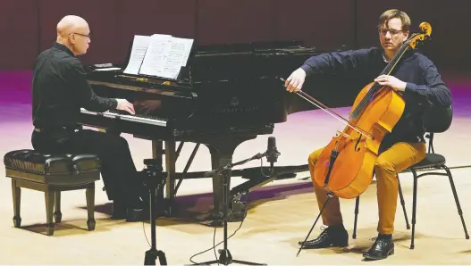  ?? LARRY WONG FILES ?? Edmonton Symphony Orchestra’s principal cellist Rafael Hoekman and regular guest pianist Jeremy Spurgeon perform to an empty concert hall at Winspear Centre in March.