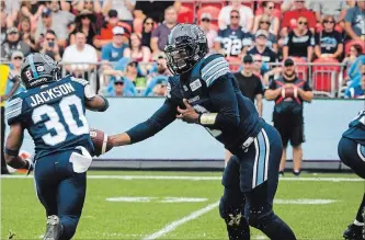  ?? CANADIAN PRESS FILE PHOTO ?? Argonauts quarterbac­k James Franklin, right, hands off to teammate Martese Jackson in first-quarter Canadian Football League action against the B.C. Lions in Toronto on Aug. 18. Franklin begins his second stint as Toronto’s starter Friday night at BMO Field against the archrival Hamilton Tiger-Cats.