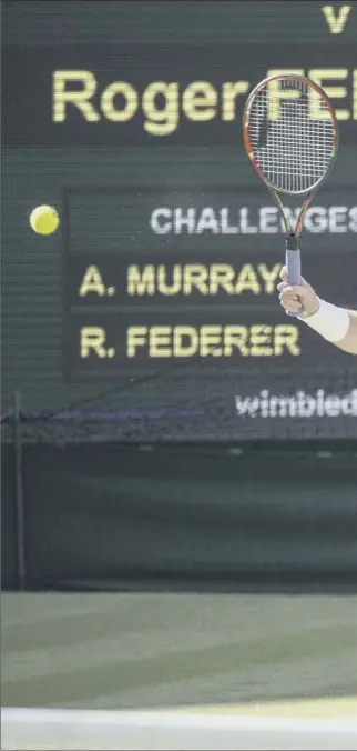  ??  ?? Andy Murray stretches to make a forehand return during the second set of his match against Roger Federer yesterday, but he had no answer to the brilliance of the 17-time major champion, who is chasing his eighth Wimbledon title