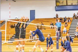  ?? Cory Rubin/The Signal (See additional photos on signalscv.com) ?? COC freshman Rachel Caruthers spikes the ball past two Vaquero blockers in a matchup with Santa Barbara at College of the Canyons on Wednesday.