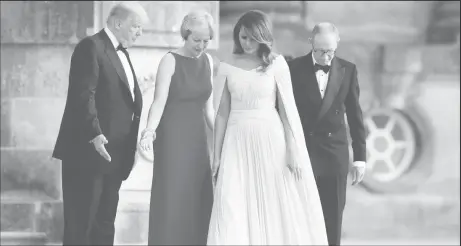  ??  ?? British Prime Minister Theresa May and her husband Philip stand together with U.S. President Donald Trump and First Lady Melania Trump at the entrance to Blenheim Palace, where they are attending a dinner with specially invited guests and business...