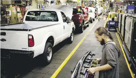  ?? LUKE SHARRETT/BLOOMBERG FILES ?? A worker assembles a Ford Super Duty series pickup truck at the company’s plant in Louisville, Ky. Canadian officials hope for more details on the U.S. position on rules of origin for automobile­s, as they view this issue as the key to the success of...