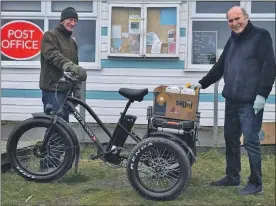  ??  ?? Graeme Stones, one of the island volunteers, delivering food from Luing Stores to islanders needing to stay inside. He is with shopkeeper Norrie Bissell.