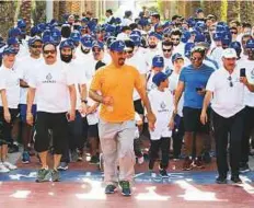  ?? Courtesy: Nakheel ?? Nakheel chairman Lootah kicked off the company’s programme for Dubai Fitness Challenge by leading hundreds of employees on a 6km walk on Palm Jumeirah yesterday.