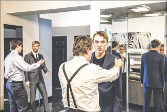  ?? GEORGE ETHEREDGE / NEW YORK TIMES ?? Randy Clark, owner of Miller’s Clothing Store in Johnstown, Pa., checks the fit of Ethan Foster’s suit last month. Clark says his family-owned business once employed twice as many people and sold 20 pairs of pants a day. Still, he’s renovated his first...