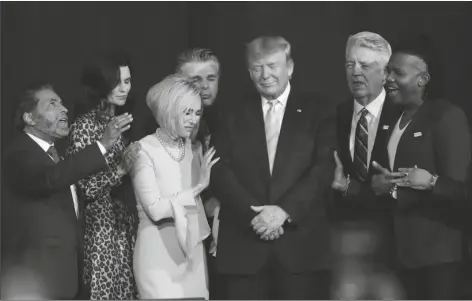  ?? ASSOCIATED PRESS ?? IN THIS FRIDAY, JAN. 3 FILE PHOTO, faith leaders pray with President Donald Trump during a rally for evangelica­l supporters at the King Jesus Internatio­nal Ministry church in Miami. The conservati­ve evangelica­l Christians who helped send Trump to the White House four years ago stuck by him again in 2020. But even if Trump doesn’t get a second term, some conservati­ve Christians see reasons to celebrate in this year’s election results.