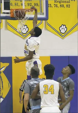  ??  ?? PHOTO BY ROB WORMAN Thomas Stone junior Kamau Mitchell dunks home two of his game-high 30 points in Friday night’s 98-45 win over visiting La Plata in the Class 2A South Section I boys basketball quarterfin­als. Mitchell also was a perfect 8 for 8 from...