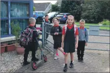  ??  ?? Time to try again. Pupils arriving back at Lamlash primary last August.