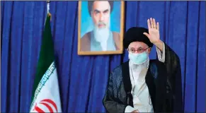  ?? ?? Supreme Leader Ayatollah Ali Khamenei waves to the crowd as he arrives at the mausoleum of the late revolution­ary founder Ayatollah Ruhollah Khomeini (shown in the poster at top center) Saturday in Tehran, Iran.
(Ap/office of the Iranian Supreme Leader)