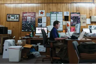  ?? Staff photo by Jerry Habraken ?? John Schrimer, owner and publisher of the Nashville News-Leader, works Wednesday at his desk. The Nashville Leader recently bought out competing Nashville paper the Nashville News.