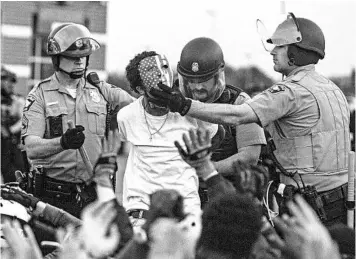  ?? VICTOR J. BLUE/THE NEW YORK TIMES ?? Police detain a protester May 31 in Minneapoli­s, where some federal and local officials blamed outsiders for stoking chaos.