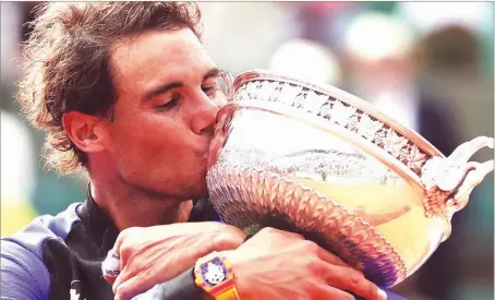  ??  ?? Nadal kissing his 10th French Open trophy after defeating Stan Wawrinka 6-2 6-3 6-1 in the final...yesterday