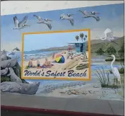  ?? ?? This mural promotes Carpinteri­a’s claim to have the world’s safest beach. The waters off the town’s wide strand are known for their lack of rip current.