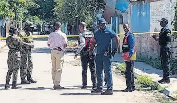  ?? PHOTO BY ANDRE WILLIAMS ?? Members of the security forces at the scene on Crescent Road in St Andrew, where two men were shot dead and another injured on Friday morning.