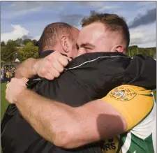  ??  ?? Giants of men! Mick Murtagh embraces his son Eoin after the final whistle of the IFC final against Kilmacanog­ue.