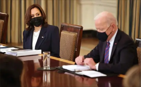  ?? Chip Somodevill­a/Getty Images ?? Vice President Kamala Harris and President Joe Biden meet with Cabinet members and immigratio­n advisers Wednesday. Mr. Biden has tapped Ms. Harris to lead his administra­tion’s efforts to address a surge of migration at the southern border.