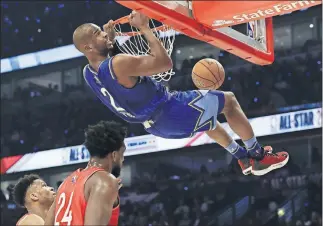  ?? PHOTOS/ THE ASSOCIATED PRESS] [NAM Y. HUH ?? Chris Paul dunks the ball during the first half of Sunday's NBA All-Star basketball game.