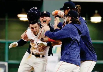  ?? ASSOCIATED PRESS PHOTOS ?? THE HOUSTON ASTROS CELEBRATE AFTER ALEX BREGMAN’S (2) GAME-WINNING SINGLE against the Los Angeles Dodgers on Monday in Houston. Astros won 13-12. during Game 5 of the World Series