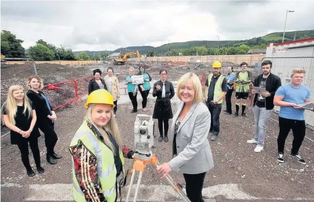  ??  ?? College students with principal Judith Evans at the site of the £22m Aberdare college campus