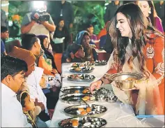  ??  ?? This handout photograph taken on Dec 7 and released by the Ambani family via Reliance Industries shows Isha Ambani (right), daughter of Reliance Industries chairman Mukesh Ambani, serving food to guests during an ‘Anna Seva’ ritual that coincides with pre-wedding functions ahead of her marriage with Anand Piramal, the son of Indian industrial­ist Ajay Piramal, in Udaipur.