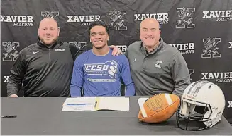  ?? Photo Courtesy of Xavier Football team ?? Xavier’s Stylz Mitchell signed his letter of intent to play football at Central Connecticu­t State University on Wednesday.