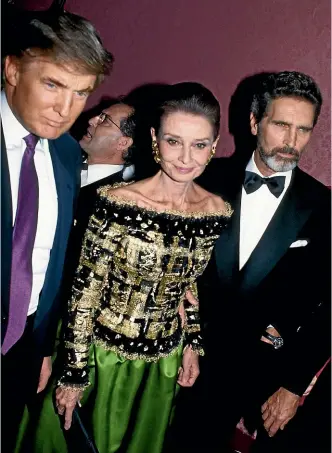  ?? GETTY ?? Robert Wolders, right, in New York in about 1992 with partner Audrey Hepburn and Donald Trump.