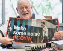  ??  ?? Fan: Jon Kotler with a poster featuring the COYW slogan