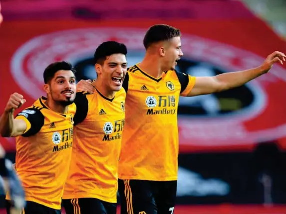 ?? (Getty) ?? Raul Jimenez, centre, celebrates after opening the scoring