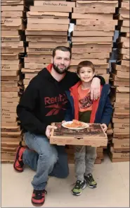  ?? JESI YOST — FOR MEDIANEWS GROUP ?? Standing in front of the large pile of pizza boxes that fed the crowd of 625, Corey Hinkle came out to Hereford Elementary’s WATCH D.O.G.S. kickoff event for a little father-son bonding with Aiden, 6.