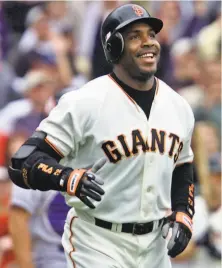  ?? Eric Risberg / Associated Press 2001 ?? Above, the Giants’ Barry Bonds begins to round the bases after his 73rd home run of the 2001 season. Right, A’s catcher Jonathan Lucroy hugs starter Sean Manaea after the lefty’s nohitter on April 21, 2018.