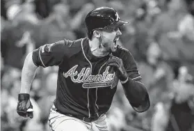  ?? Jeff Roberson / Associated Press ?? Atlanta’s Adam Duvall reacts after hitting a two-run single in the ninth inning during Game 3 of the NLDS. The Braves went on to win for a 2-1 series lead.