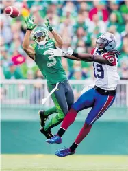  ?? BRENT JUST/ GETTY IMAGES ?? The Roughrider­s’ Macho Harris intercepts a pass in front of Alouettes receiver S.J. Green, who was held to one catch for 15 yards in the contest on Saturday.