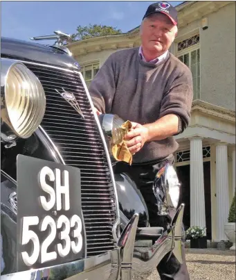  ??  ?? Jim Pickens gets back to work cleaning the historic Kilsharvan car after 65 years .