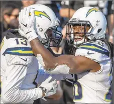  ?? Robert Gauthier Los Angeles Times ?? MELVIN GORDON (28) celebrates his 66-yard touchdown with Keenan Allen in the third quarter. Gordon had 165 total yards.