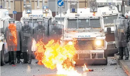  ?? REUTERS ?? A fire burns in front of the police on the Springfiel­d Road as protests continue in Belfast, Northern Ireland.
