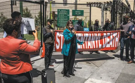  ?? Stephen Lam / The Chronicle ?? Jacqui Berlin, who says her son is addicted to fentanyl, speaks during a protest in May at Turk and Hyde streets in S.F.