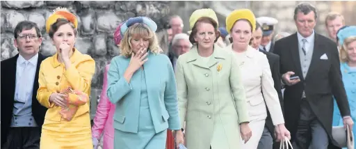  ?? ARWYN ROBERTS ?? Actors in 1960s clothes for the filming of The Crown at Caernarfon