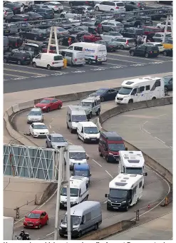  ??  ?? Home early...vehicles streaming off a ferry at Dover yesterday