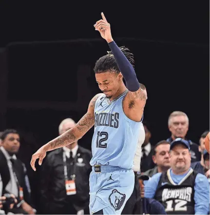  ?? BRANDON DILL/AP ?? Grizzlies guard Ja Morant, shown during a Feb. 1 game against the Portland Trail Blazers in Memphis, has been accused of threatenin­g mall security about four days before allegedly punching a teen during a basketball game.