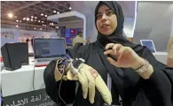  ??  ?? Hessa Al Shehi explains the Deaf’s Dream Smart Glove, which on display at the Dubai Police pavilion.