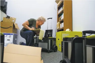  ?? Lacy Atkins / Special to the Chronicle ?? Suzie Lindsay prepares batteries at the Disability Services & Legal Center in Santa Rosa.