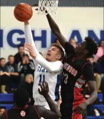  ?? MATHEW MCCARTHY, RECORD STAFF ?? Maksim Koprivica, left, of SJAM goes to the basket with Eastwood Collegiate’s Hanani Ujullu defending, Friday. SJAM won in overtime.